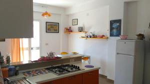 A kitchen or kitchenette at Appartamenti Alba e Tramonto