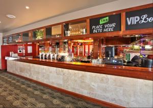 a bar in a restaurant with a counter at Kingsgrove Hotel in Sydney