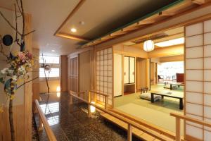 a japanese house with a view of the living room at Hotel Futaba in Yuzawa