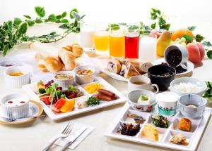 a table with several plates of food and drinks at Kobe Hotel Fruit Flower in Kobe