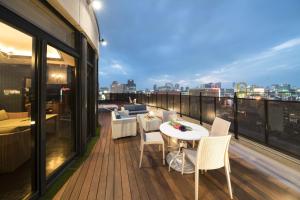a balcony with a table and chairs on a building at Hotel Alps in Osaka