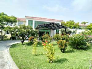 um jardim com plantas em frente a um edifício em Excelsior Resort em Dili