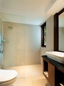 a bathroom with a sink and a toilet at Mangsit Suites by Holiday Resort Lombok in Mangsit