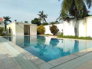 a swimming pool in front of a house at Beach Garden Hotel in Dili