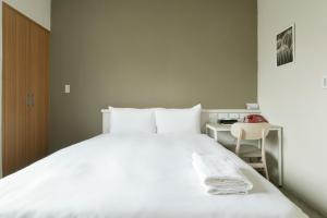 Voodi või voodid majutusasutuse Raise Hotel Taichung toas