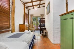 a bedroom with a bed and a desk in a room at Taradale House Estate in Taradale