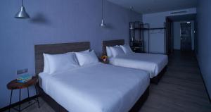 Postel nebo postele na pokoji v ubytování Urban H Hotel