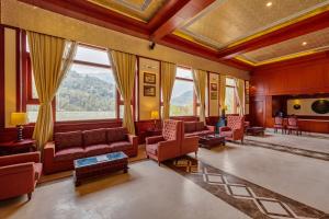 a living room with red furniture and large windows at Sterling Gangtok Orange Village in Gangtok