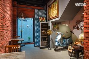 a living room with a scooter parked in a room at 108 House Inn in Tainan