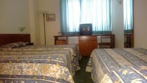 Postel nebo postele na pokoji v ubytování Park Hotel Galileo