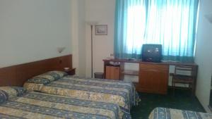 Postel nebo postele na pokoji v ubytování Park Hotel Galileo