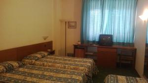 Postel nebo postele na pokoji v ubytování Park Hotel Galileo