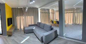 a living room with a couch and a table at Brand new luxurios loft by the sea in Mamaia Nord