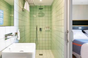 a bathroom with a shower with a toilet and a sink at Hotel Brummell in Barcelona