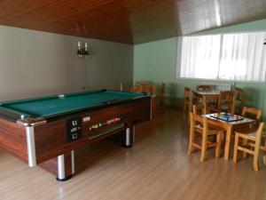 Habitación con mesa de billar, mesa y sillas. en Hotel Escalar, en Panticosa