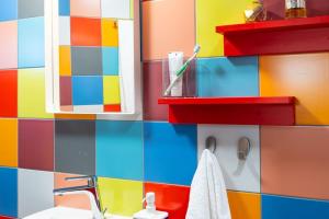 a colorful bathroom with a sink and a mirror at Deco city center apartment in Heraklio +29 photos