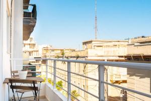 a balcony with a table and a view of a city at Deco city center apartment in Heraklio