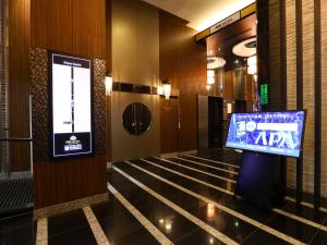 a room with a large screen tv on the wall at APA Hotel Asakusa Kuramae in Tokyo
