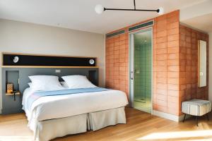 a bedroom with a bed and a glass shower at Hotel Brummell in Barcelona