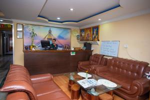 a waiting room with leather couches and a counter at The Boudha Inn in Kathmandu