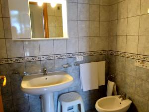 a bathroom with a sink and a toilet at Case Vacanze Ancora in Porto Empedocle
