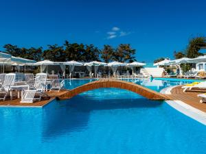 a bridge over a pool at a resort at Chora Resort Hotel & Spa in Chora Folegandros