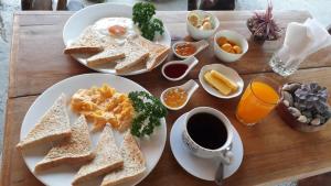a table with two plates of toast and a cup of coffee at Baleh Boble Guesthouse in Banaue