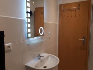 a bathroom with a sink and a mirror at Bitscher str.70 in Zweibrücken +26 photos