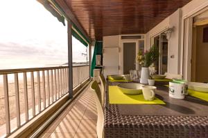 a balcony with a table with a view of the ocean at Homes & Go Bell Reco Deluxe I in La Pineda