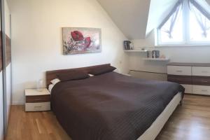 a bedroom with a large bed in a room at Superior-Apartment mit Pool und Seezugang in Velden am Wörthersee +31 photos