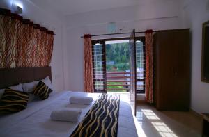 Tempat tidur dalam kamar di Pine Tree Munnar
