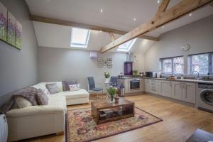 a living room with a couch and a table at Little Oak by RentMyHouse in Hereford