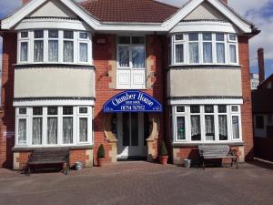 a house with a blue sign on the front of it at Clumber House Hotel in Skegness