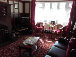 a living room with a couch and a table at Clumber House Hotel in Skegness