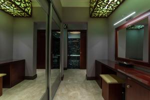 a bathroom with two sinks and a mirror at Warwick Al Khobar in Al Khobar