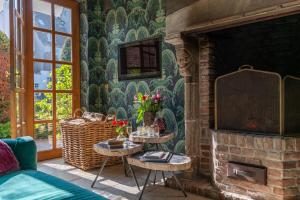 a living room with a fireplace with two tables at Exclusive Suites The Secret Garden in Bruges