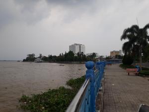 a blue fence next to a body of water at An Loc Motel in Vĩnh Long