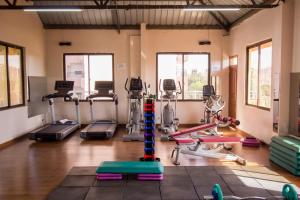 a gym with several exercise bikes and treadmills at Paleo Hotel and Spa in Thika