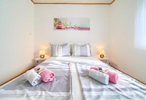 a bedroom with a bed with three pillows on it at Apartments Braut Krk in Krk