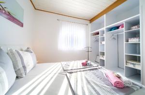 a room with a bed with a glass table at Apartments Braut Krk in Krk