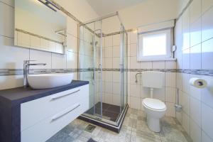 a bathroom with a sink and a toilet at Apartments Braut Krk in Krk