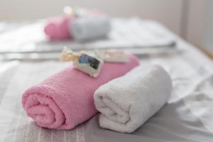 a pink towel with a stuffed animal on a bed at Apartments Braut Krk in Krk