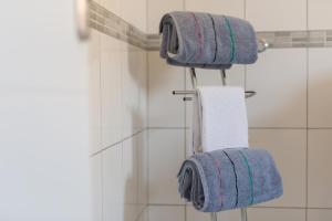 a bathroom with three towels hanging on a rack at Apartments Braut Krk in Krk