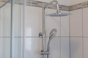 a shower with a shower head in a bathroom at Apartments Braut Krk in Krk