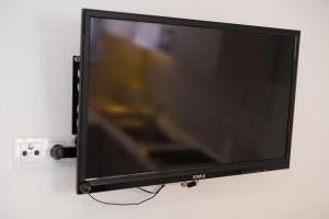 a flat screen tv hanging on a wall at Apartments Braut Krk in Krk