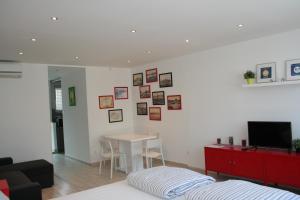 a bedroom with a bed and a table and a tv at Broadway Center Rooftop View Apartment in Budapest