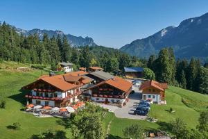 an aerial view of a resort with cars parked in a field at Alpenhotel Hundsreitlehen in Bischofswiesen