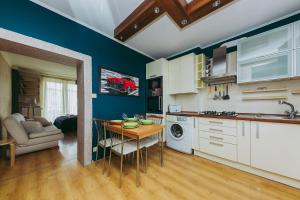 a kitchen with a table and a dining room at ShortStayPoland Leszno (B53) in Warsaw