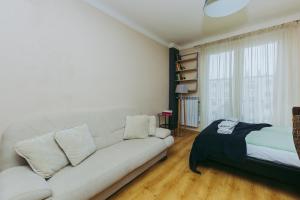 a living room with a white couch and a window at ShortStayPoland Leszno (B53) in Warsaw