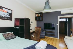 a bedroom with a bed and a desk and a tv at ShortStayPoland Leszno (B53) in Warsaw